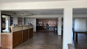 a lobby of a hotel with a bar and a kitchen at Microtel Inn & Suites by Wyndham Ardmore in Ardmore