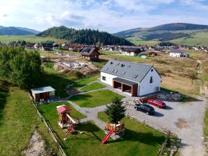 an aerial view of a white house with a playground at Apartmány Paľovci in Zuberec