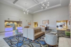 a living room with a couch and chairs at Holiday Inn Express Hotel & Suites Oshkosh - State Route 41, an IHG Hotel in Oshkosh