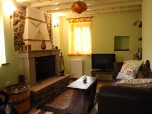 a living room with a fireplace and a couch at Villa Notia in Skala Eresou
