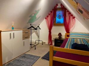 a bedroom with a bed and a dresser at Ferienwohnung Dinkelscherben in Dinkelscherben
