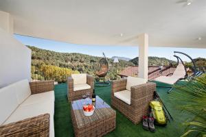 a patio with chairs and a table with a view at Felsenegg in Nalles