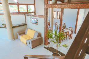 a living room with a couch and a table at Pousada Porto Da Barra in Porto Seguro