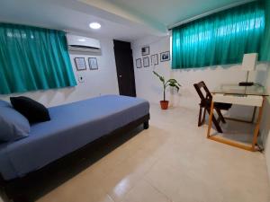 Postel nebo postele na pokoji v ubytování Downtown Hostel Chetumal