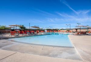 a large swimming pool with chairs and umbrellas at The Lodge at Ventana Canyon in Tucson
