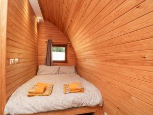 a small bed in a wood paneled room at Halmore Pod in Berkeley