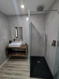 a bathroom with a sink and a shower at northsouthviescasinha in Calheta