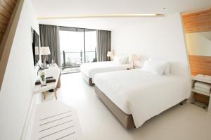 Postel nebo postele na pokoji v ubytování Centara Q Resort Rayong