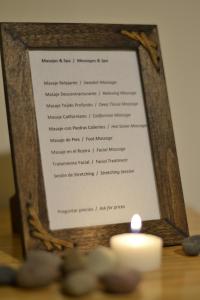 a picture of a menu with a candle at Boedo Tango Apartment in Buenos Aires