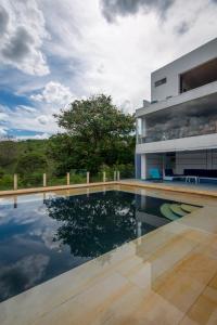 a swimming pool in front of a house at Terrazas De Baltimoores in San Joaquín