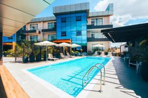 a swimming pool in front of a building at Blackwood Boutique Hotel and Apartments in Dar es Salaam
