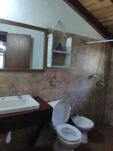 a bathroom with a toilet and a sink at Piccolo Paradiso in La Pedrera