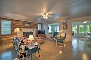 a living room with a couch and a fireplace at Kentucky Lake Cabin with Private Dock and Fire Pit in New Concord