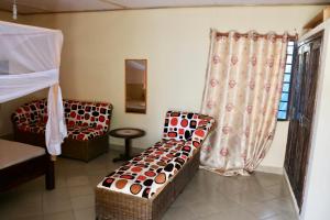 a room with two chairs and a couch and a window at Room in Guest room - A wonderful Beach property in Diani Beach Kenyaa dream holiday place in Mombasa