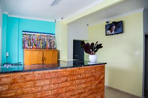 a room with a counter with a painting on the wall at Relaxing Guest House in th Heart of Ndabeni in Cape Town +22 photos