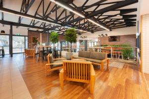 a lobby with couches and chairs and a bar at Alivio Tourist Park Canberra in Canberra