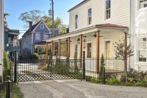 a black fence in front of a white house at The Charlestonian in Charleston