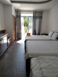 Кровать или кровати в номере Resort Bao Anh Sunset Beach