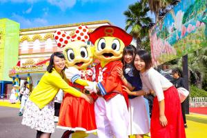 a group of girls posing with goofy costumes at a parade at Ooedo Onsen Monogatari Hotel Reoma no Mori in Marugame