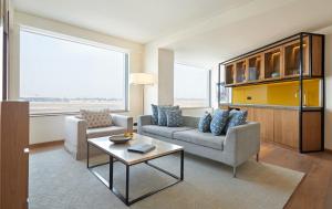 a living room with two couches and a table at Andaz Delhi Aerocity- Concept by Hyatt in New Delhi