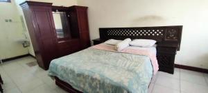 a bedroom with a bed with two pillows on it at Mangkuyudan Hotel Solo in Lawean