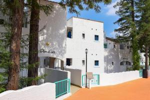 a white building with trees in front of it at Ooedo Onsen Monogatari Hotel Reoma no Mori in Marugame