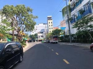 a street with cars parked on the side of the road at Restfull apartment-14 Mai Thuc Lan, My An , Da nang in Danang
