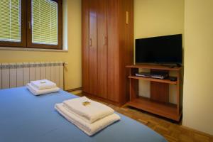 a room with a bed with two towels on it at Apartments Mery in Kolašin