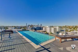 a swimming pool on the roof of a building at KOZYGURU WEST END 10 MINS TO CITY 1 BED APT + FREE PARKING QWE017 in Brisbane