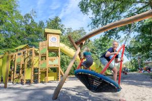 two children are playing on a playground at RCN Vakantiepark de Roggeberg in Appelscha