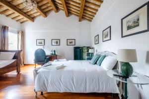 a bedroom with a white bed and a glass table at Casa Pimpotta in Ravenna