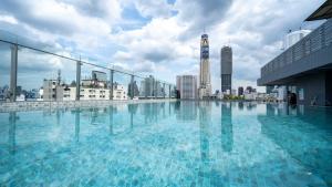 a large swimming pool on top of a building at Pannarai Hotel Bangkok-Pra tunam in Bangkok