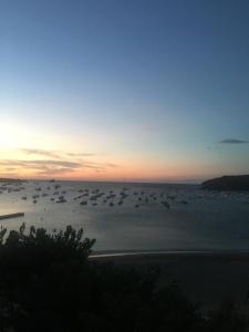 a group of boats in the water at sunset at Casas del Mar in Cadaqués