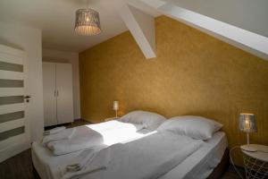 A bed or beds in a room at Apartmany Pisek