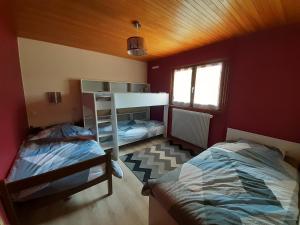 a bedroom with two beds and a bunk bed at Chalet Les Chardons in Gérardmer