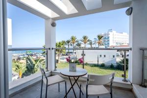 a balcony with a table and chairs and a view of the city at Villa Nora in Protaras