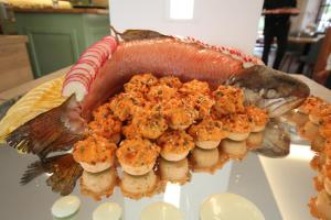 a fish on top of a plate with food on it at zeitlos Hotel und Restaurant am Fuchsbach in Pattensen