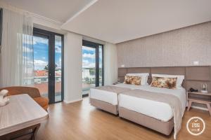 Postel nebo postele na pokoji v ubytování Essence Inn Marianos Hotel