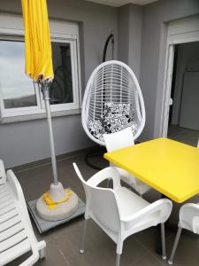 a dining room with a yellow table and a fan at Apartment Villa Franci Pag with heating and open all year in Pag +85 photos