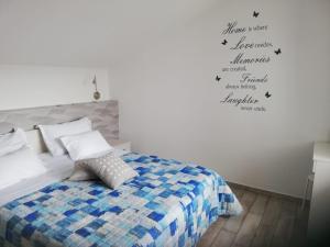 a bedroom with a bed and words on the wall at Apartment Villa Franci Pag with heating and open all year in Pag