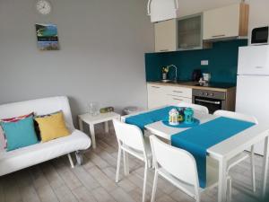 a kitchen and dining room with a table and a couch at Apartment Villa Franci Pag with heating and open all year in Pag