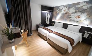 a hotel room with a bed and a painting on the wall at Pannarai Hotel Bangkok-Pra tunam in Bangkok +18 photos