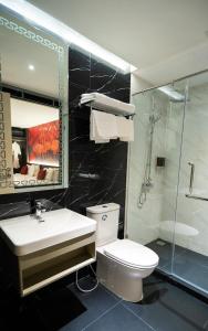 a bathroom with a toilet and a sink and a shower at Pannarai Hotel Bangkok-Pra tunam in Bangkok