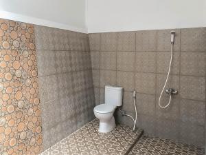 a bathroom with a toilet and a shower at RedDoorz Resort near Darajat Garut in Garut