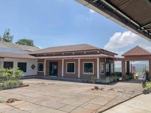 a home with a patio and a building at RedDoorz Resort near Darajat Garut in Garut