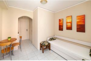 a living room with a bench and a table at Poseidon Apartments in Agia Effimia
