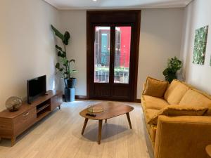 a living room with a couch and a coffee table at La puerta verde - CASCO VIEJO-OLD TOWN in Bilbao