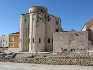 a group of people sitting on the steps of a building at Downtown Main Street Studio in Zadar