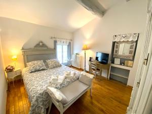 a bedroom with a bed and a chair in it at Le Moulin de Rudelle in Muret