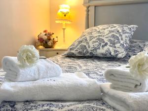 a bed with towels on it with a pillow and a lamp at Le Moulin de Rudelle in Muret